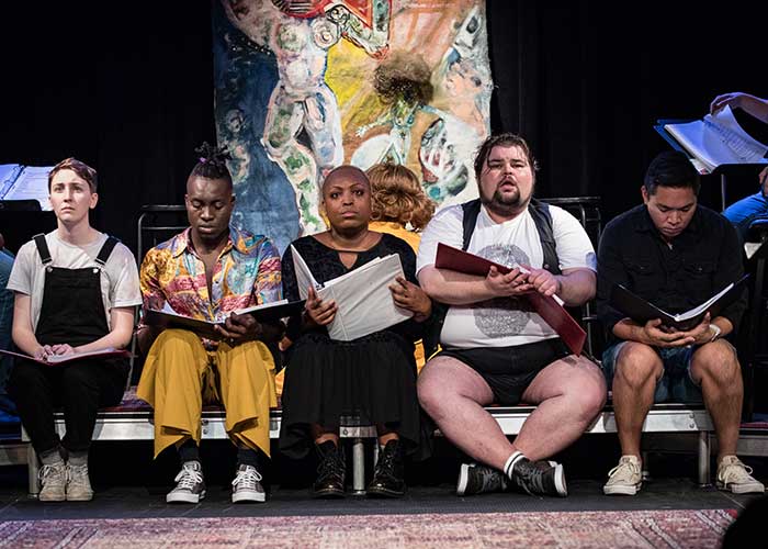 Five members of the company from the show The Church of the Alien Love Child reading from their scripts.